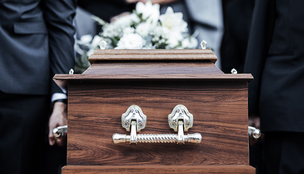 Photo of Pallbearers Carrying Ornate Casket