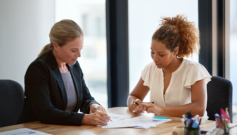 Photo of Two Women Reviewing Legal Documents