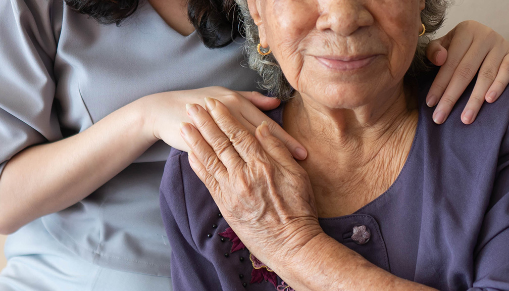 Photo of Elderly Woman With Young Caregiver Next to Her