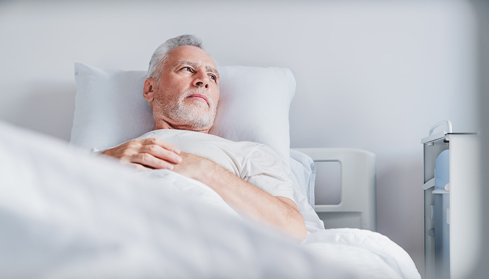 Photo of Contemplative Man in Hospital Bed