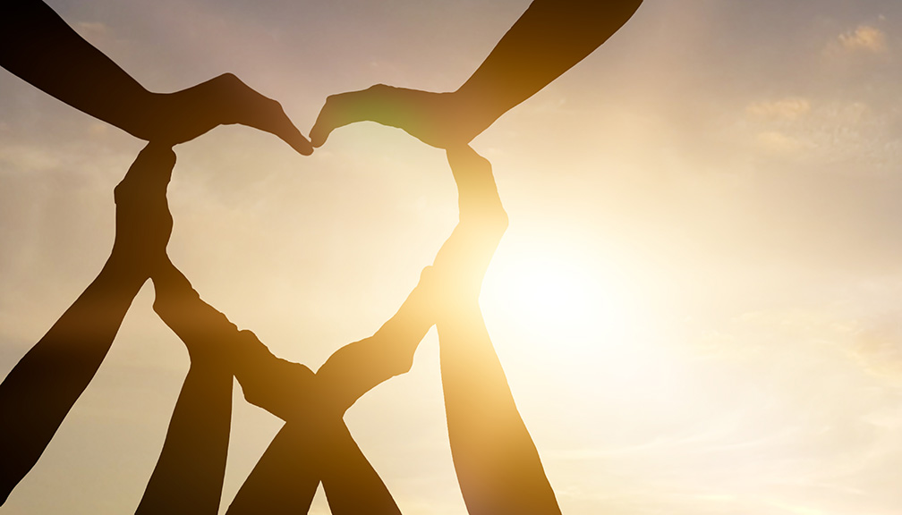 Photo of a Group of People Making a Heart With Their Hands