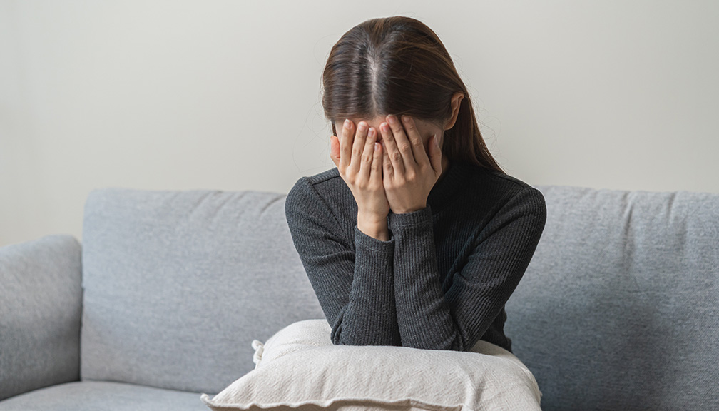 Photo of Young Woman Grieving With Face in Hands