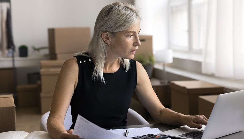 Photo of Woman on Computer Sifting Through Documents